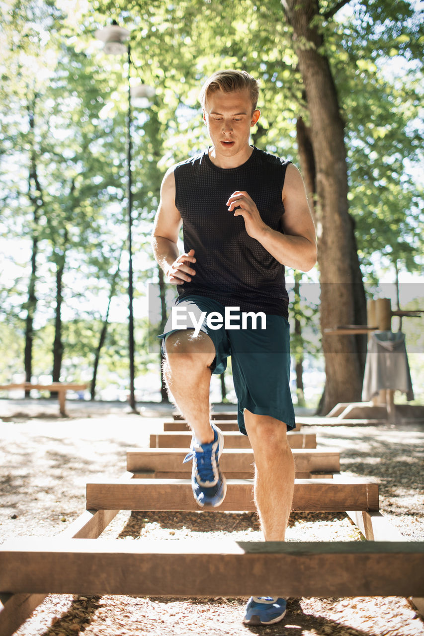 Full length of man exercising at outdoor gum