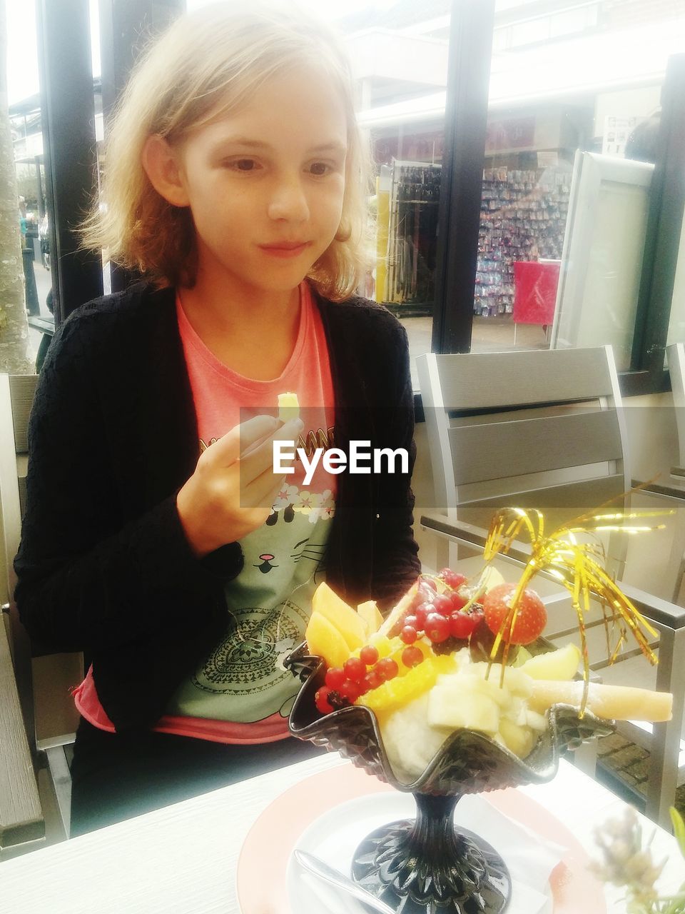 GIRL LOOKING AT FOOD AT HOME IN KITCHEN