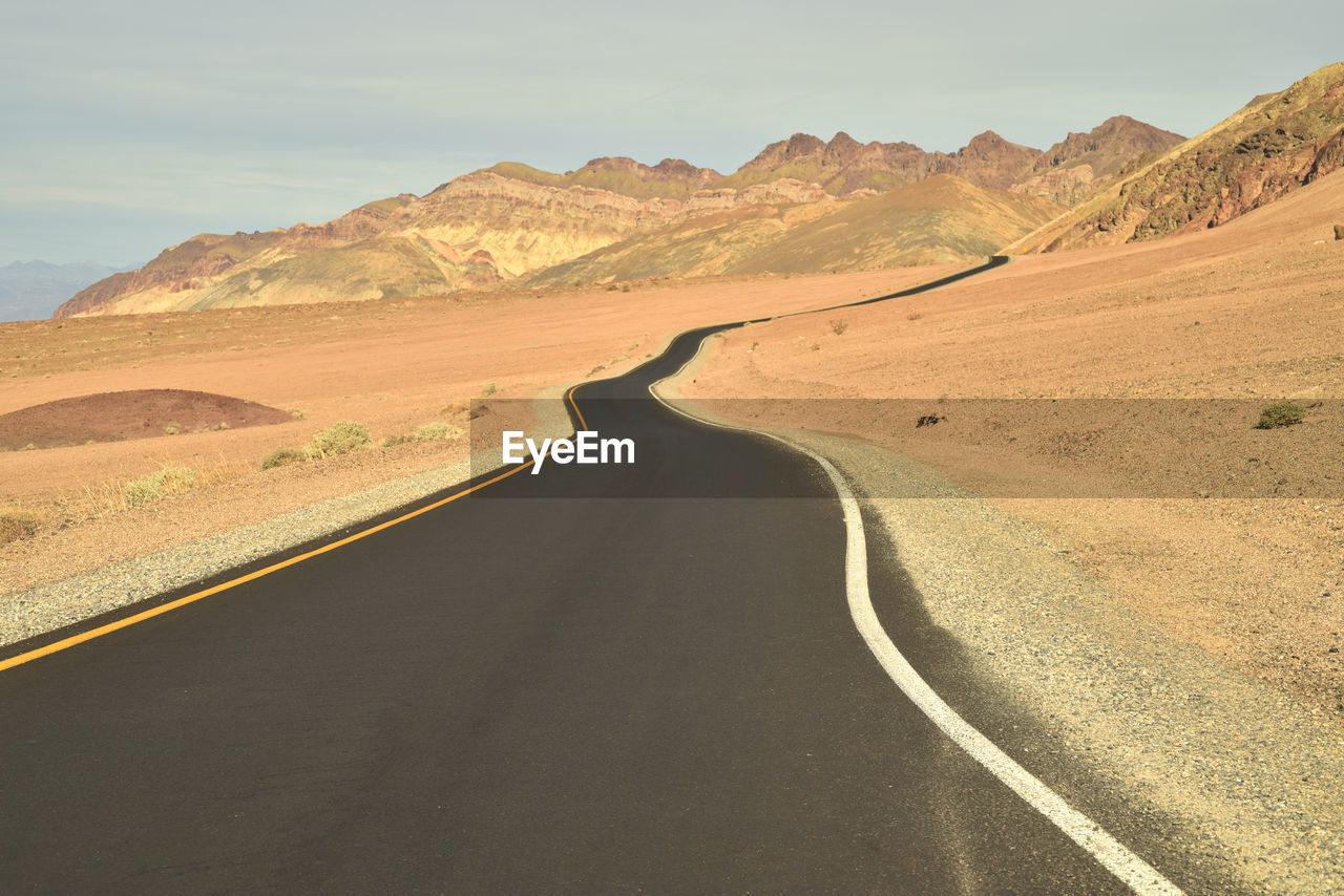 Road amidst landscape against sky