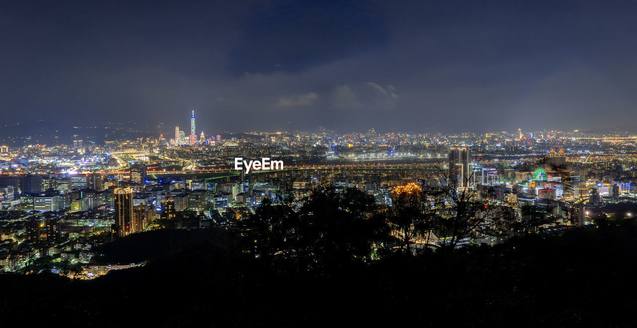 High angle view of city lit up at night