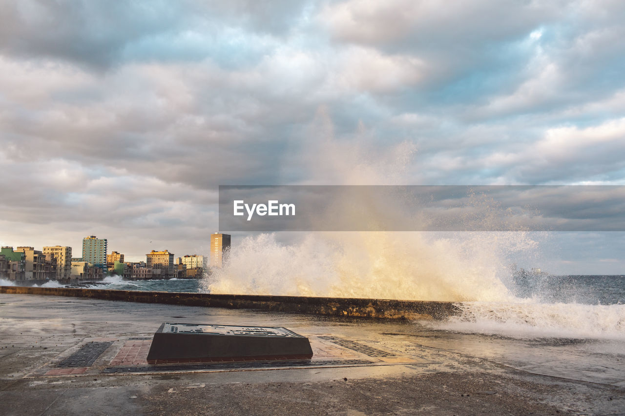 Panoramic view of sea and buildings against sky