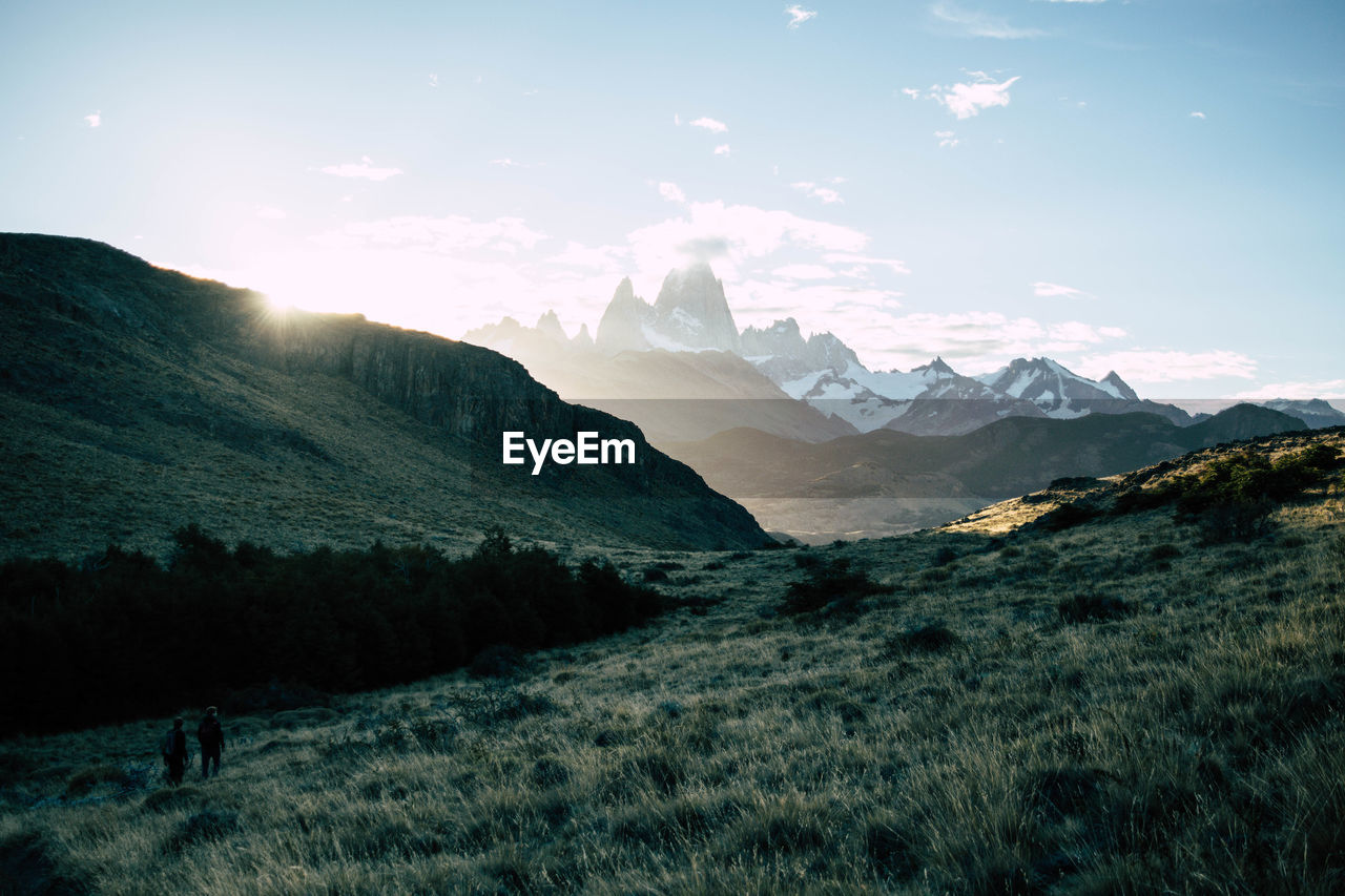 Scenic view of snowcapped mountain peak against sunset sky