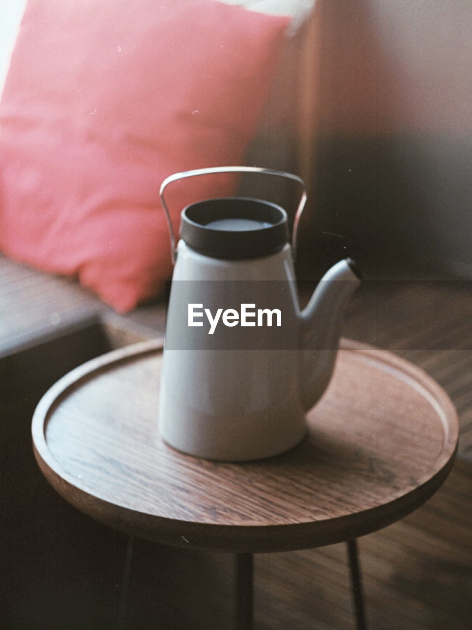 Close-up of teapot on side table