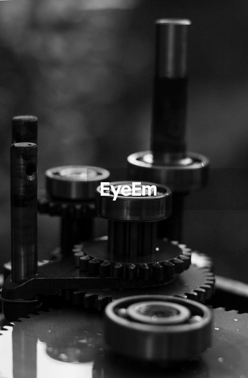 CLOSE-UP OF MACHINE PART ON TABLE AT FACTORY