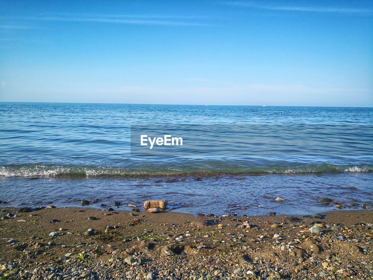 Scenic view of sea against blue sky