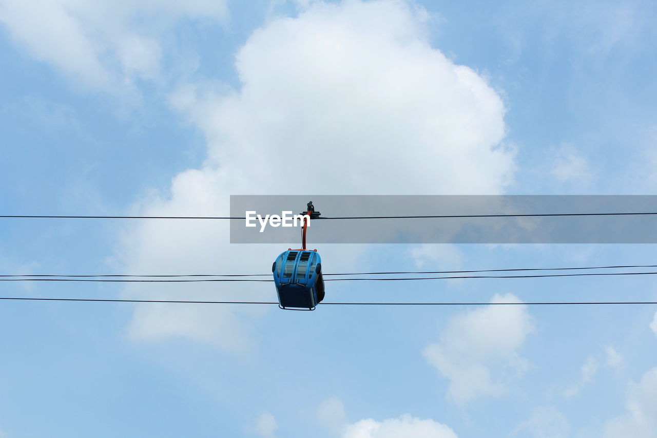 Low angle view of cable car against blue sky