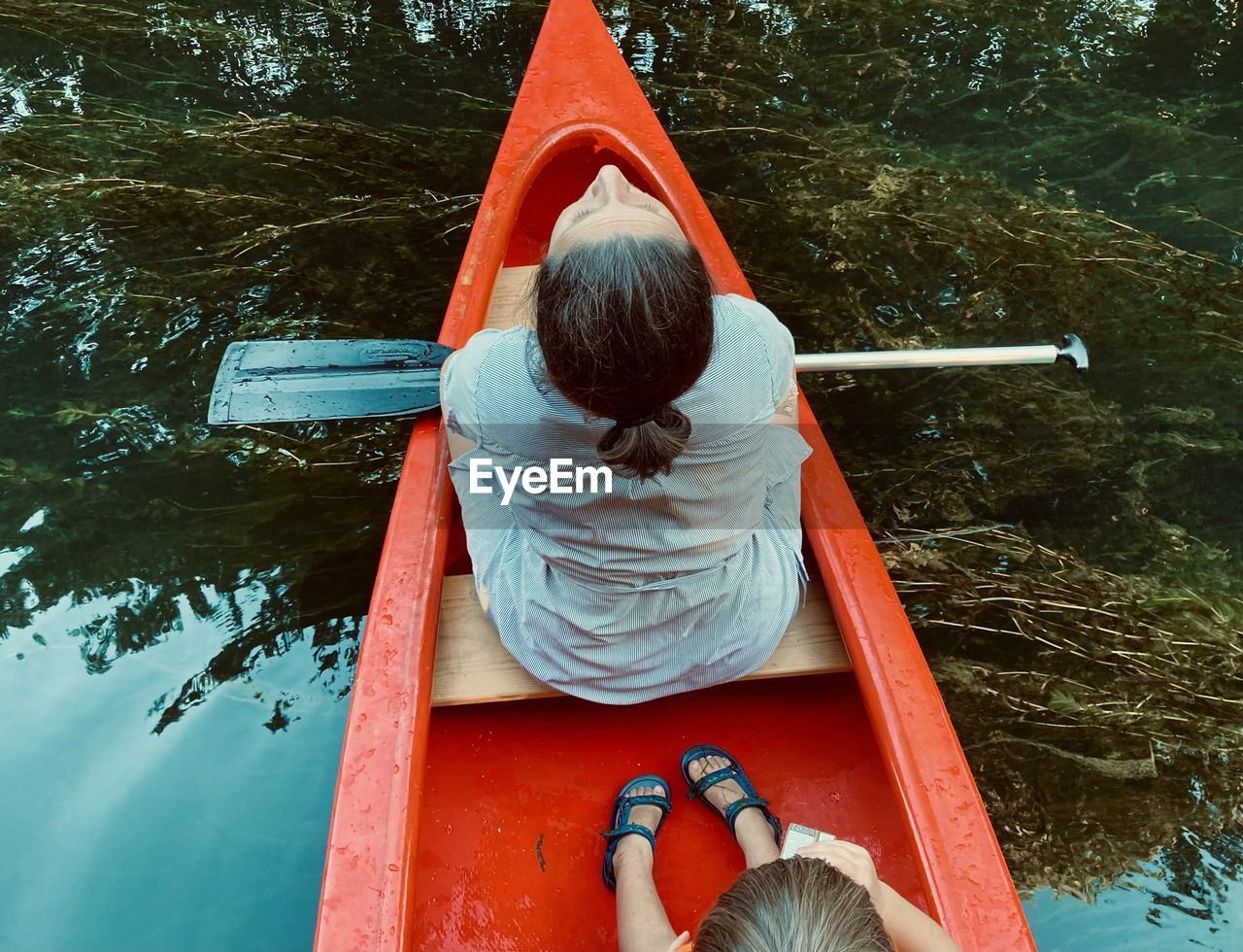 Rear view of man sitting on boat at playground