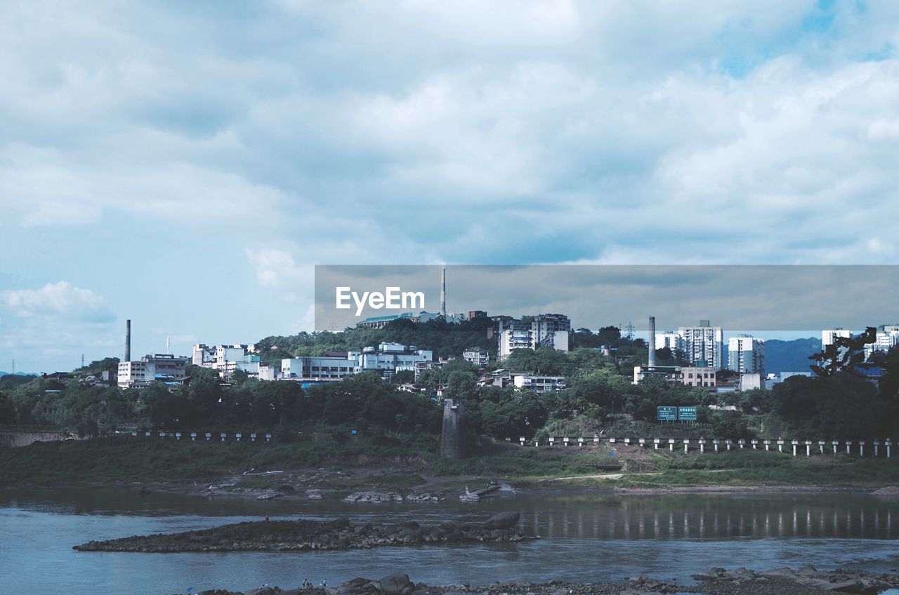 VIEW OF RIVER WITH BUILDINGS IN BACKGROUND