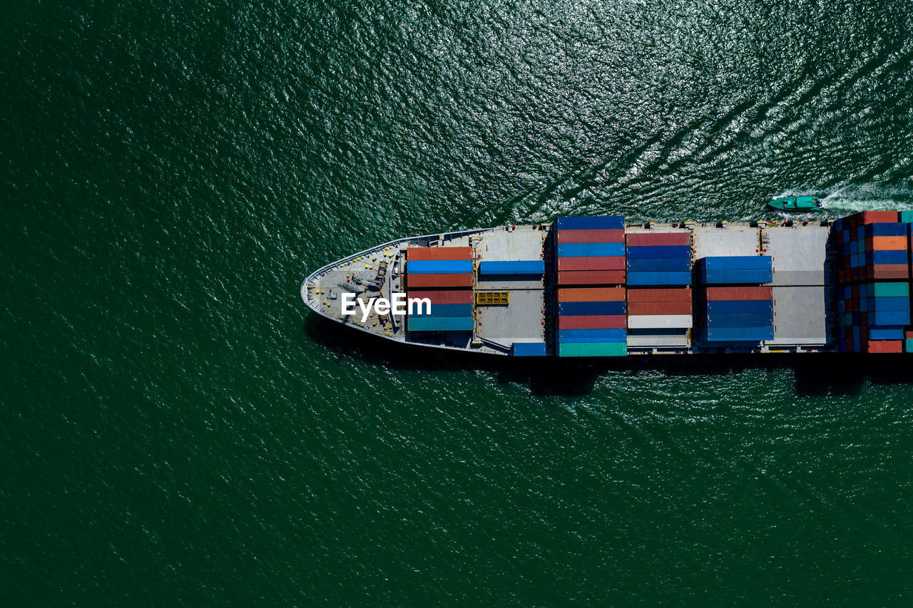 Containers ship import and export international businesses services by the sea aerial view 
