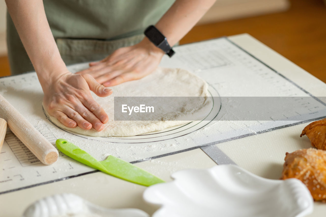 midsection of man preparing food on table in office