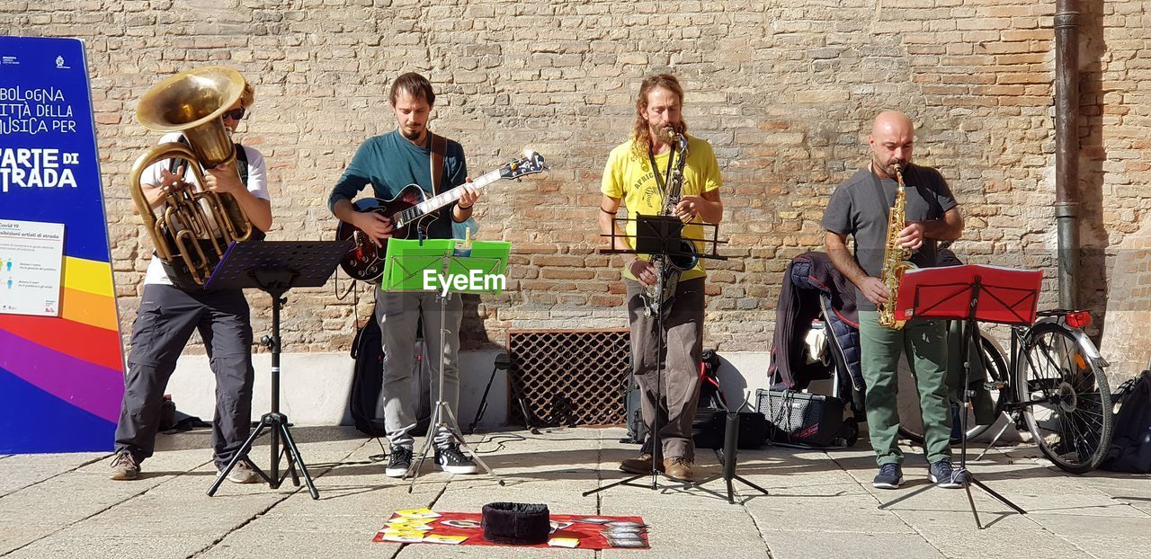 PEOPLE PLAYING GUITAR ON WALL