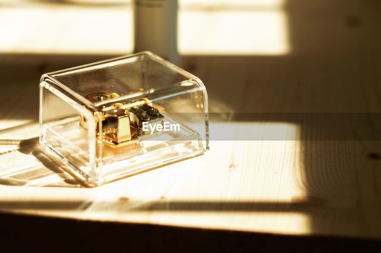 Close-up of jewelry in glass container in box on table