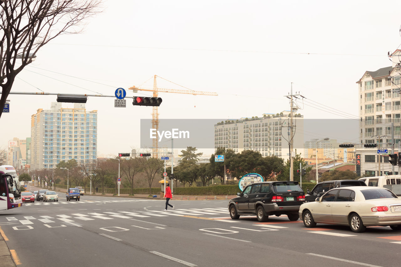 CARS ON STREET AGAINST CLEAR SKY