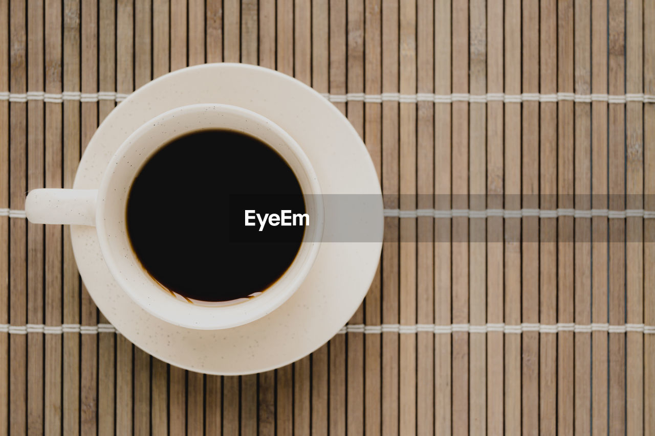 HIGH ANGLE VIEW OF BLACK COFFEE IN CUP ON TABLE