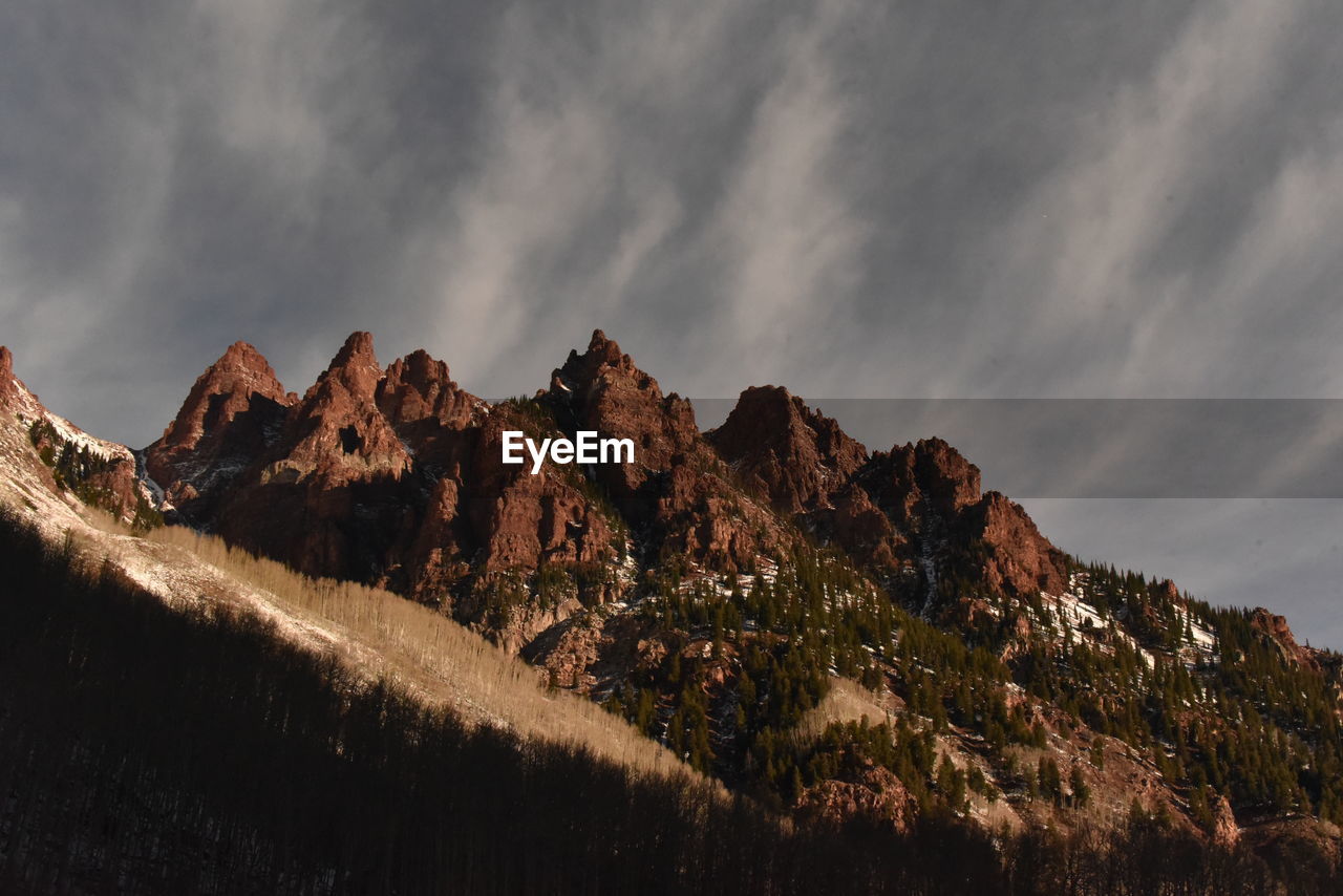 Low angle view of mountain range against sky