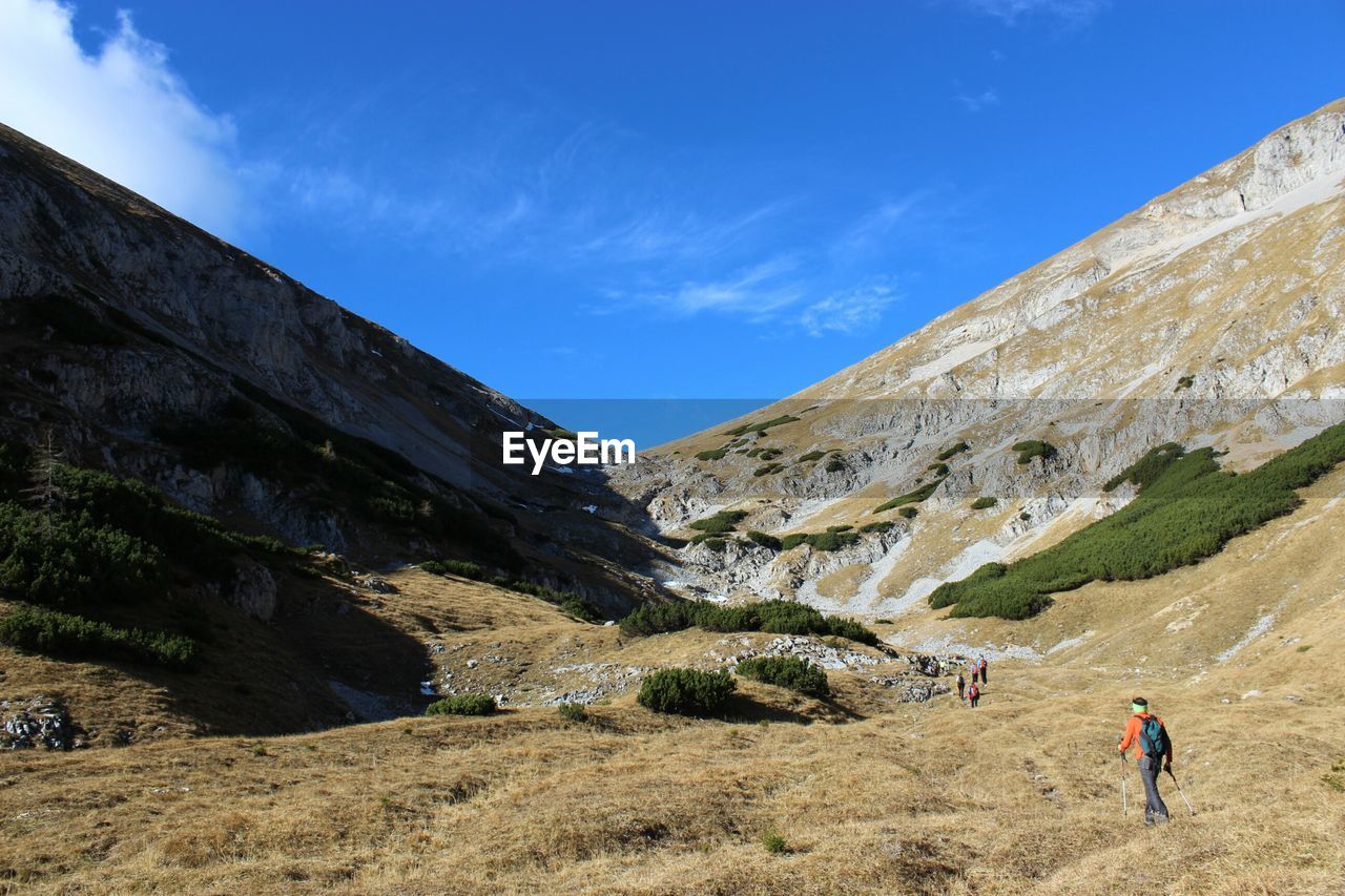 Rear view of man hiking on mountain