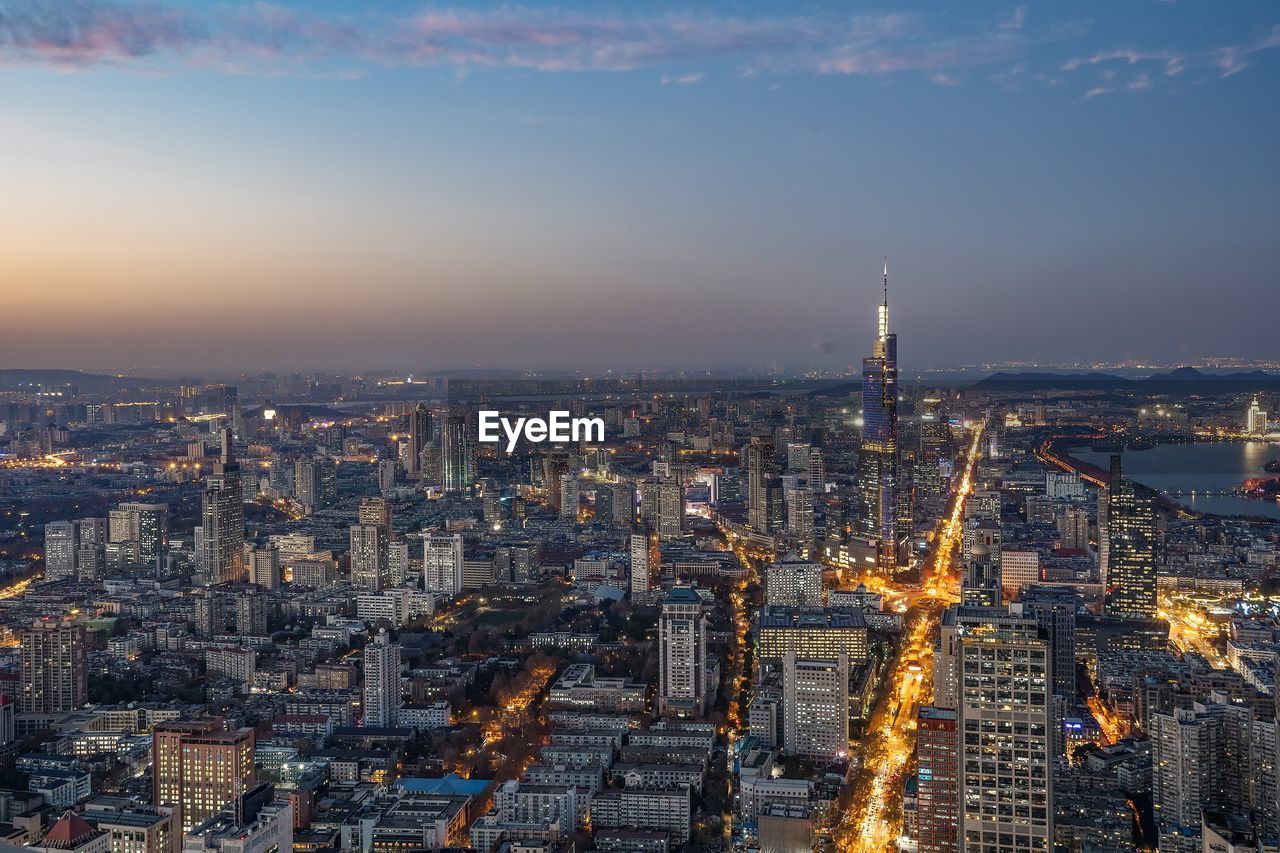 High angle view of city lit up at night