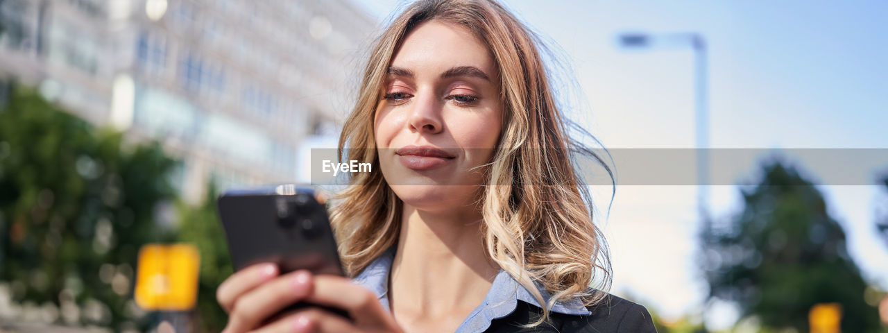 portrait of young woman using mobile phone