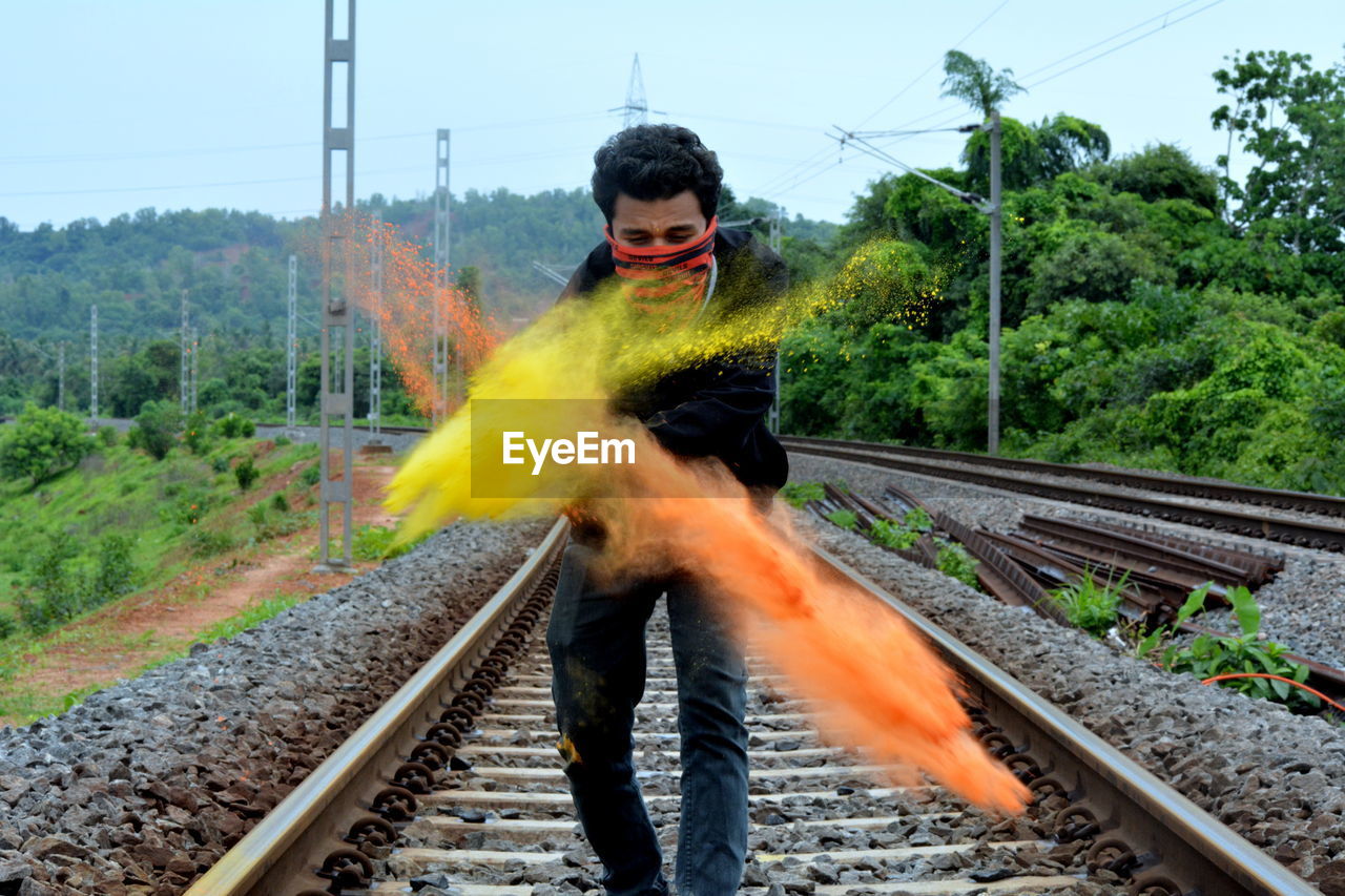 TRAIN ON RAILROAD TRACK BY TREES