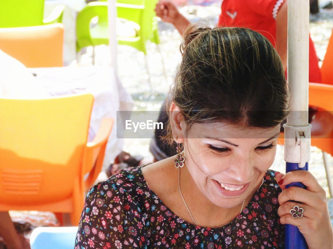 Close-up of smiling woman sitting outdoors