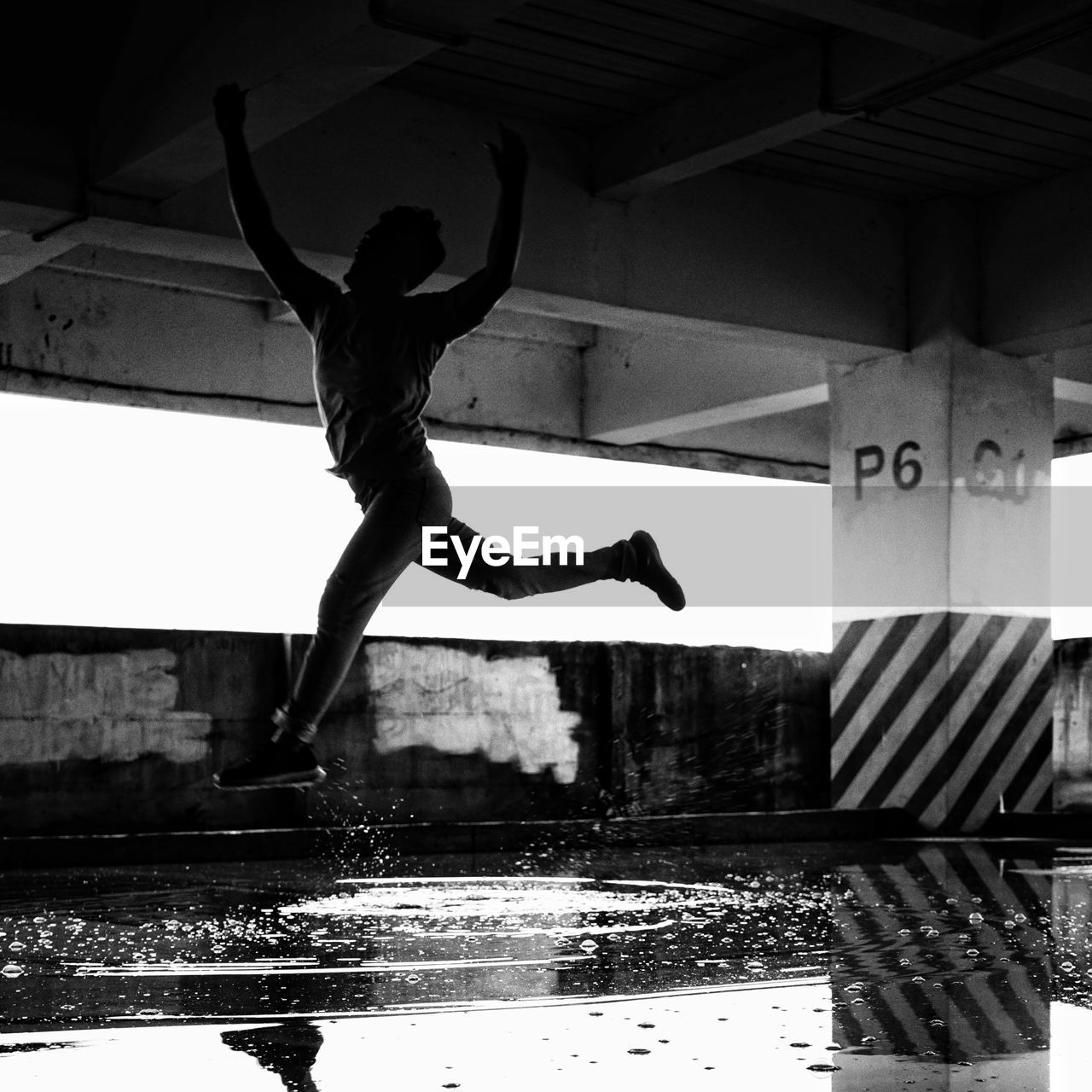 Full length of man jumping on water