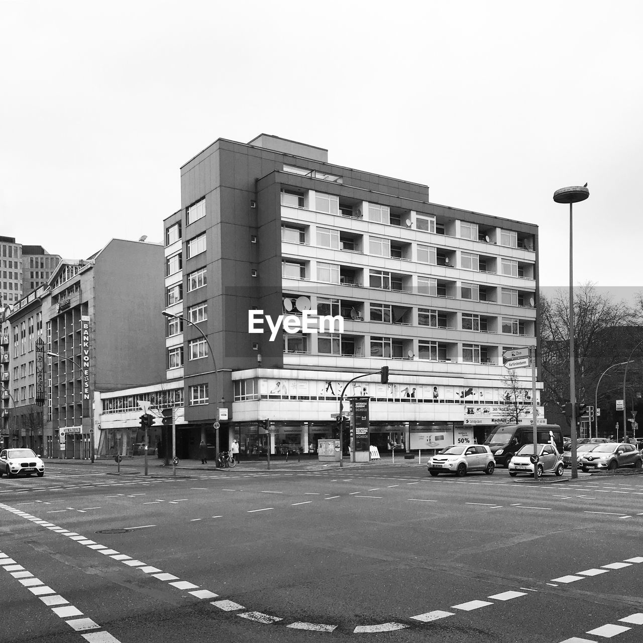 CARS ON ROAD AGAINST BUILDINGS