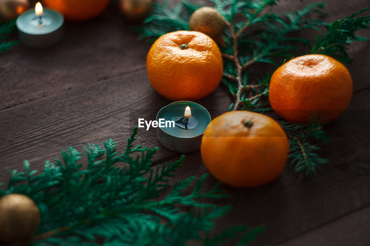 Christmas new year background with tangerines and a wreath of fir branches winter still.