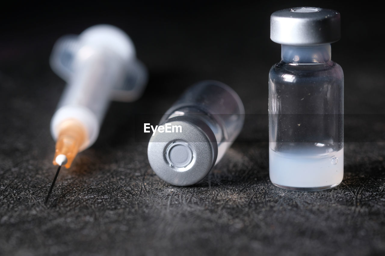 CLOSE-UP OF BOTTLES ON TABLE AT HOME