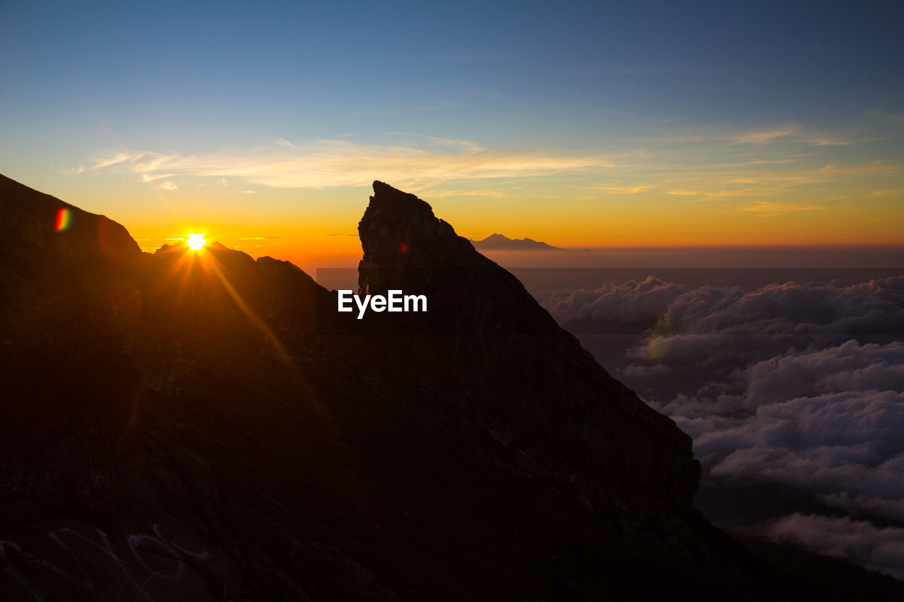 Scenic view of mountains against sky during sunset