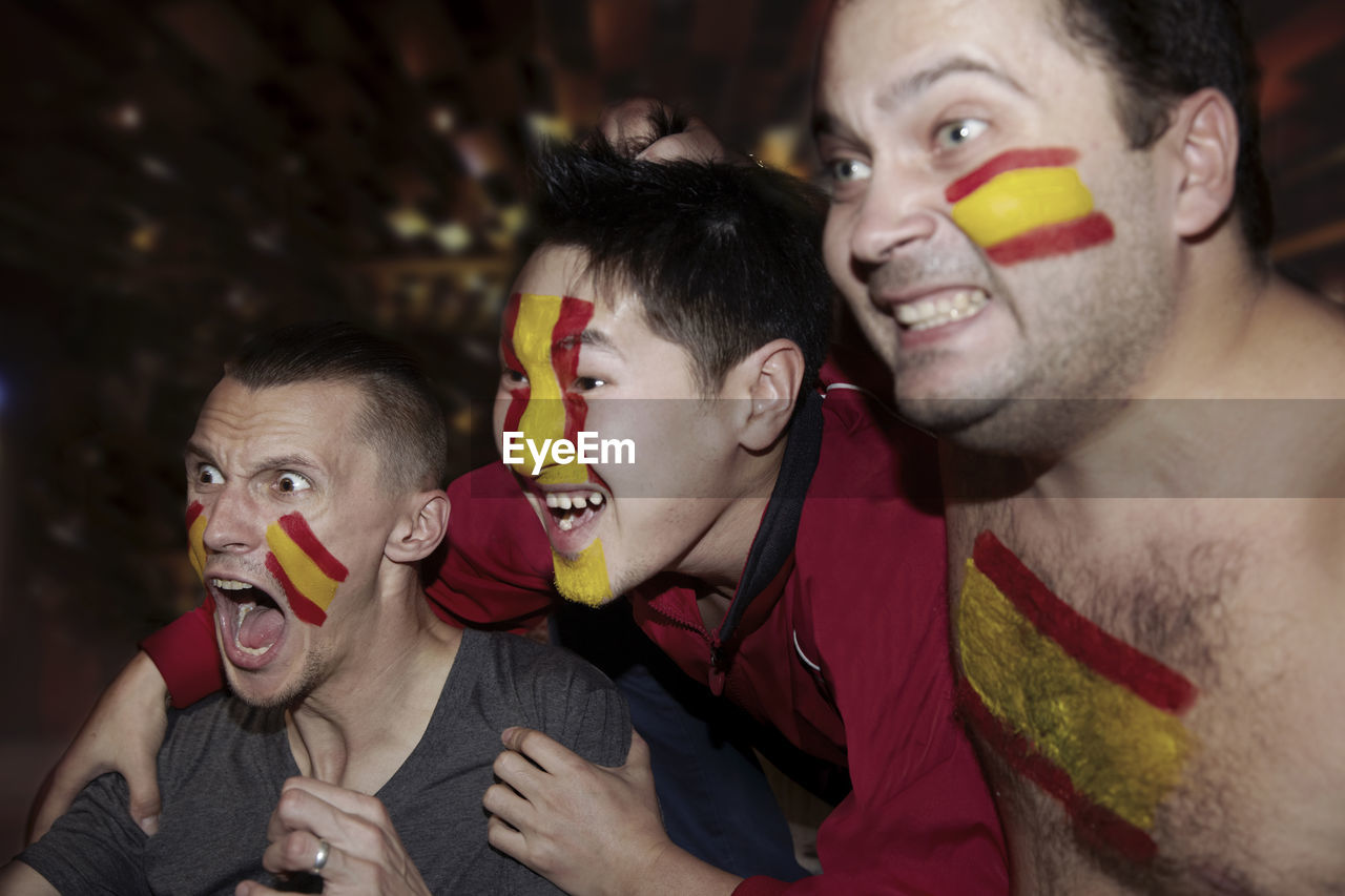 Soccer fans watching tv in pub