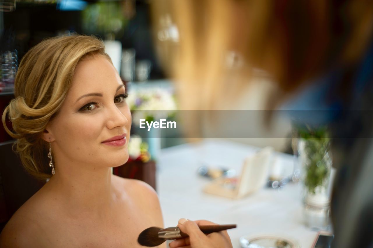 Beautiful bride sitting at table during wedding