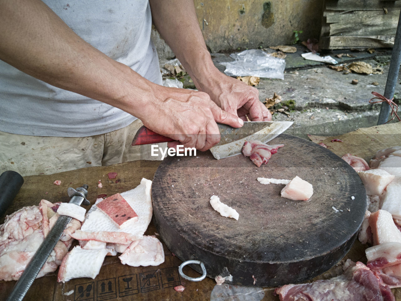 HIGH ANGLE VIEW OF MAN WORKING ON BARBECUE