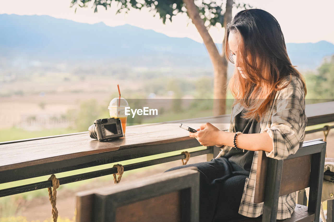 Young woman traveller use mobile phone