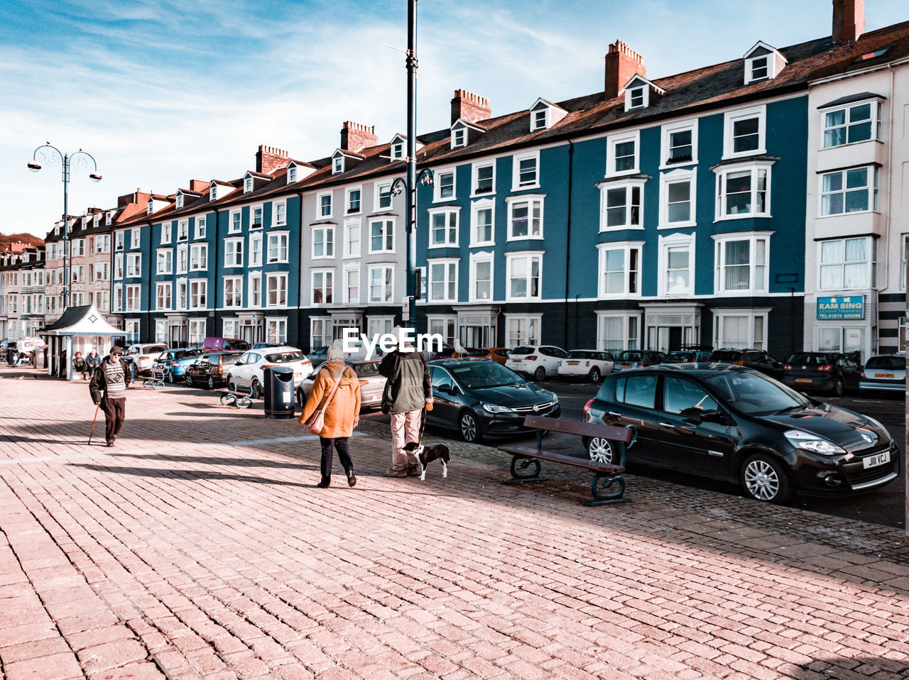 PEOPLE WALKING ON STREET BY BUILDINGS IN CITY