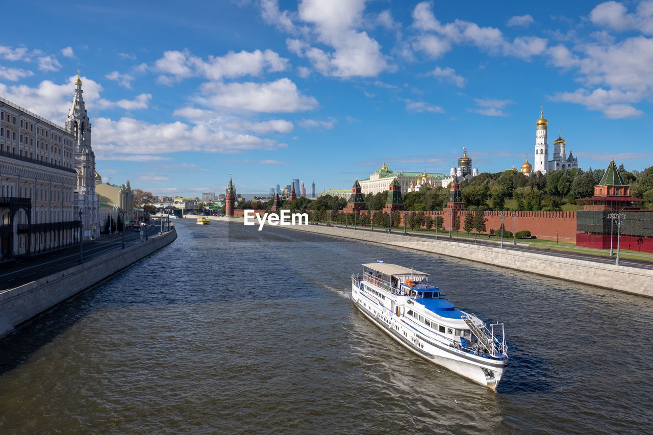 View of river in city against cloudy sky