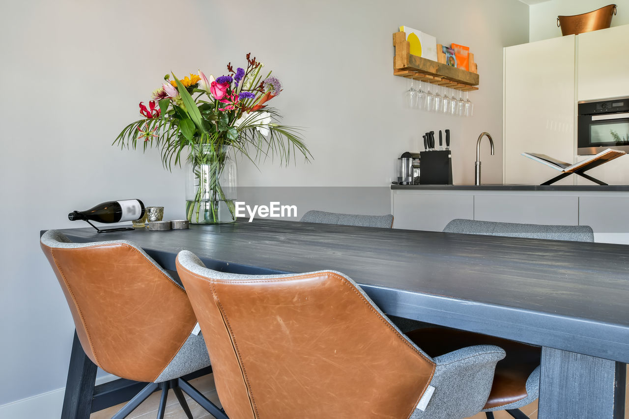 POTTED PLANT ON TABLE BY CHAIR AT HOME