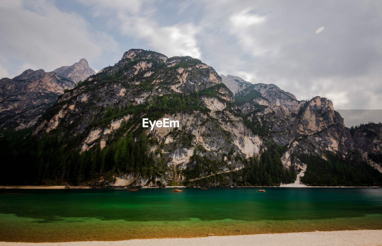 Scenic view of sea and mountains against sky