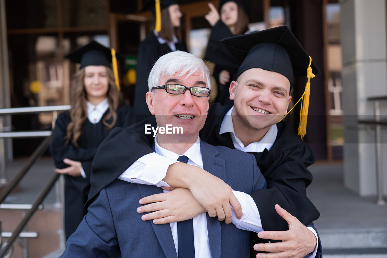 portrait of woman wearing graduation gown standing in city