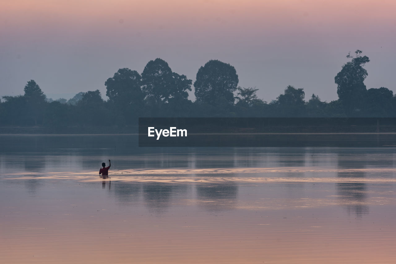 SILHOUETTE OF MAN IN WATER