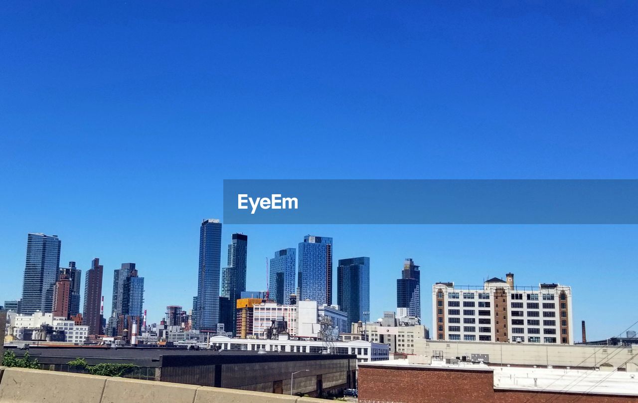 VIEW OF BUILDINGS AGAINST BLUE SKY