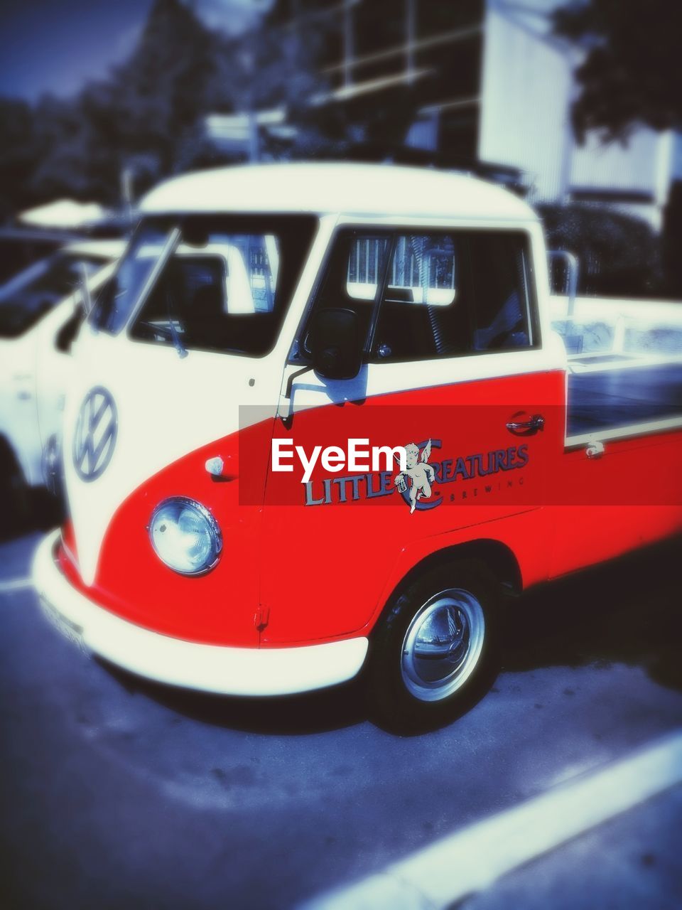 CLOSE-UP OF RED CAR ON ROAD