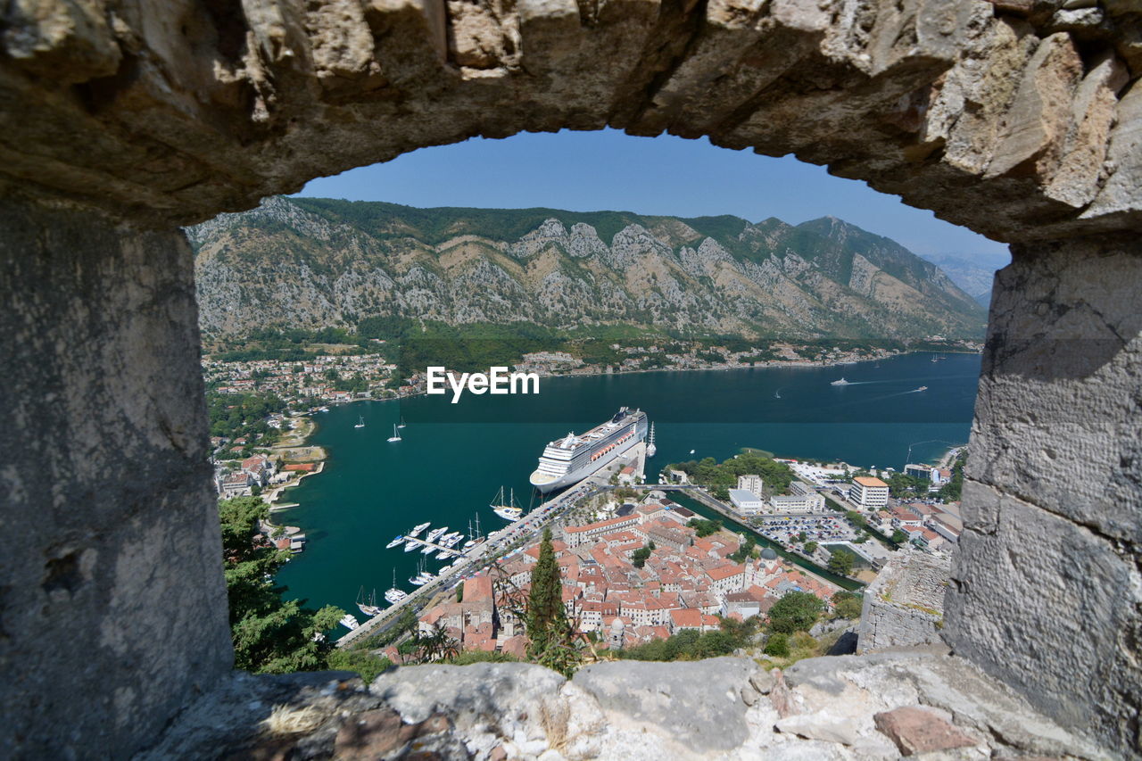 High angle view of mountain by sea seen through window