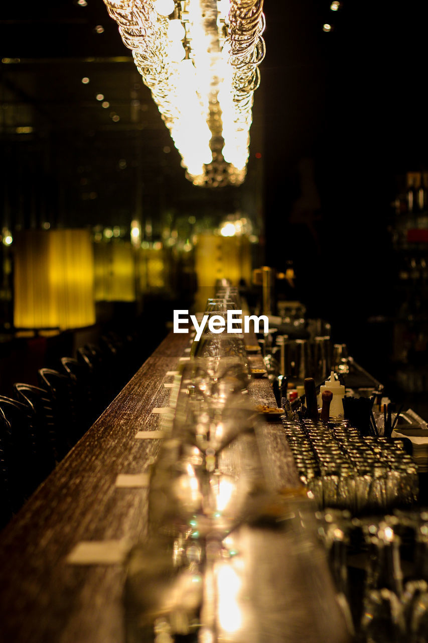 Row of wineglass on bar counter at nightclub