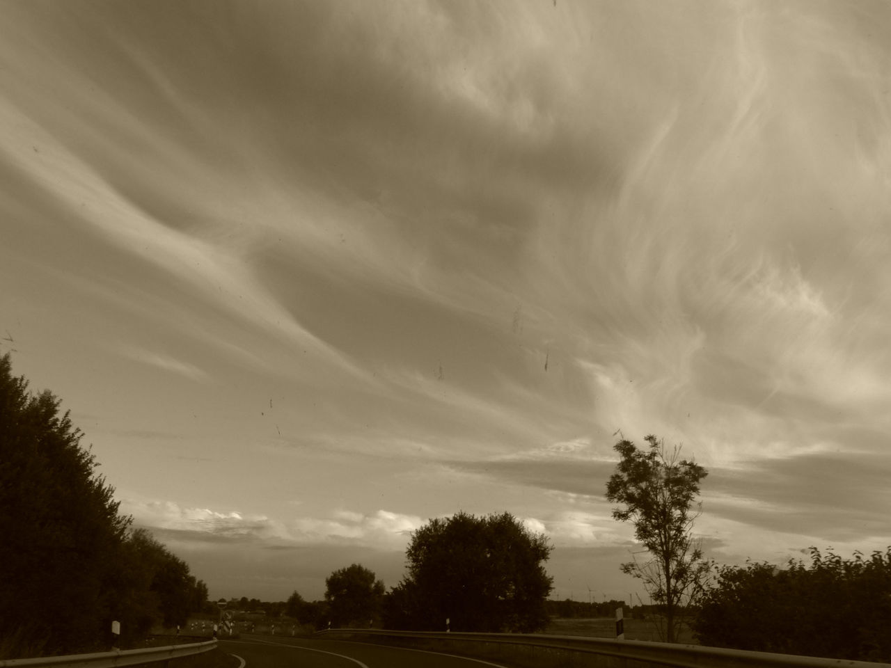 VIEW OF STORM CLOUDS OVER ROAD