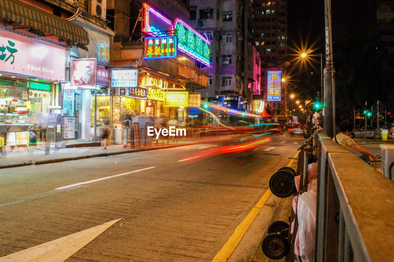 BLURRED MOTION OF ILLUMINATED STREET AT NIGHT