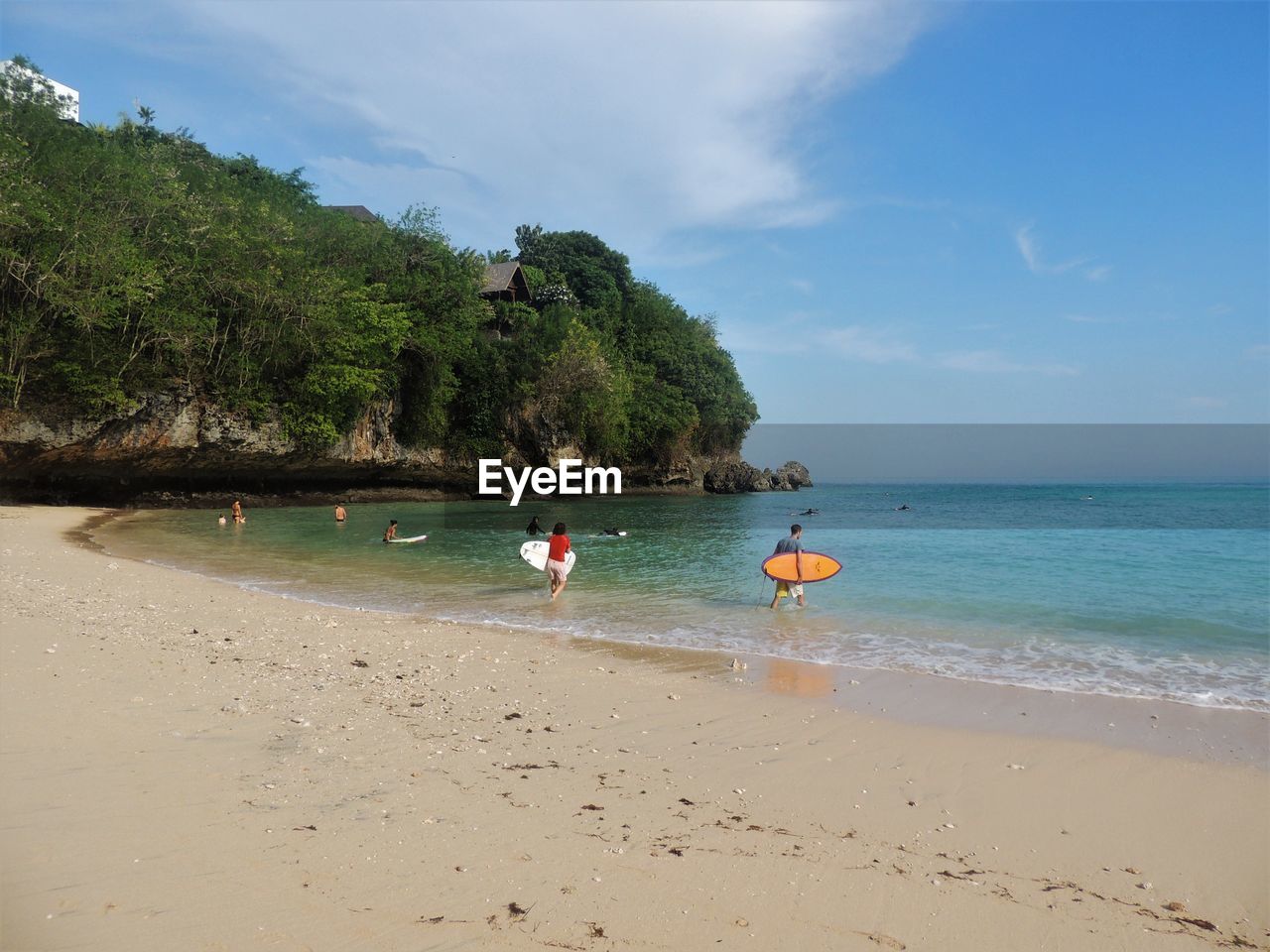 People at beach against sky