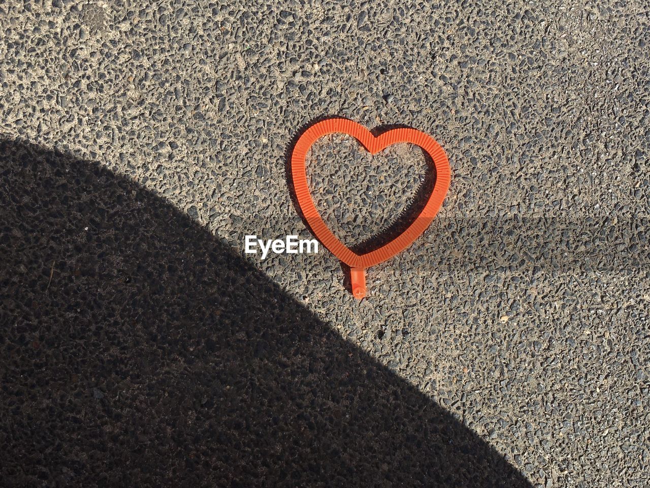 High angle view of heart shape on sand