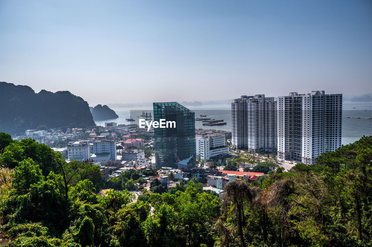 High angle view of trees and buildings against sky