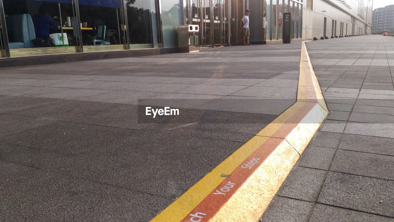 Text on sidewalk against buildings in city