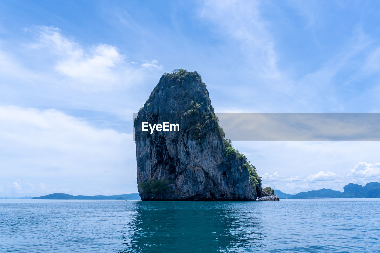 Rock formation in sea against sky